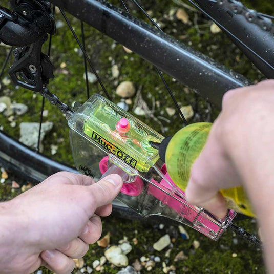 Muc-Off X3 Chain Cleaner in use on mountain bike chain